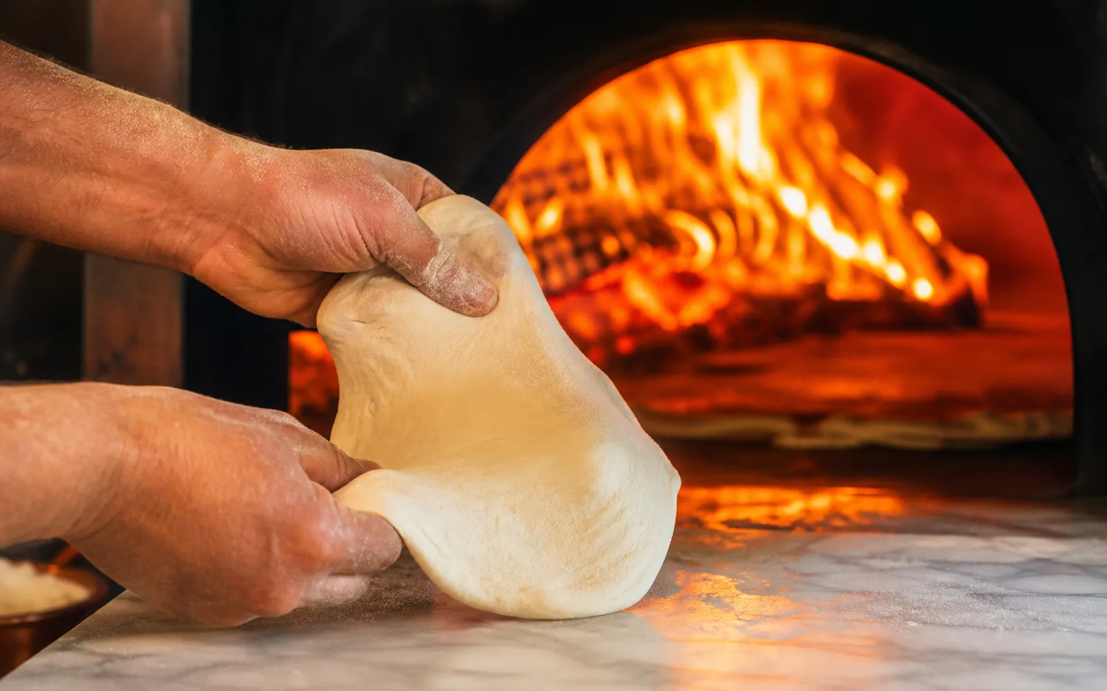 Traditional Neapolitan pizza being served at a wood-fired pizzeria