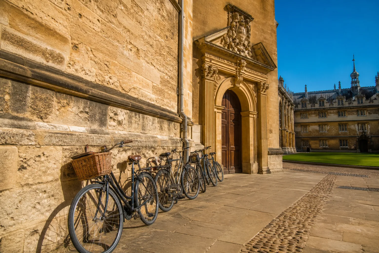 Bicycles against a honey-stone Italian university wall in morning light