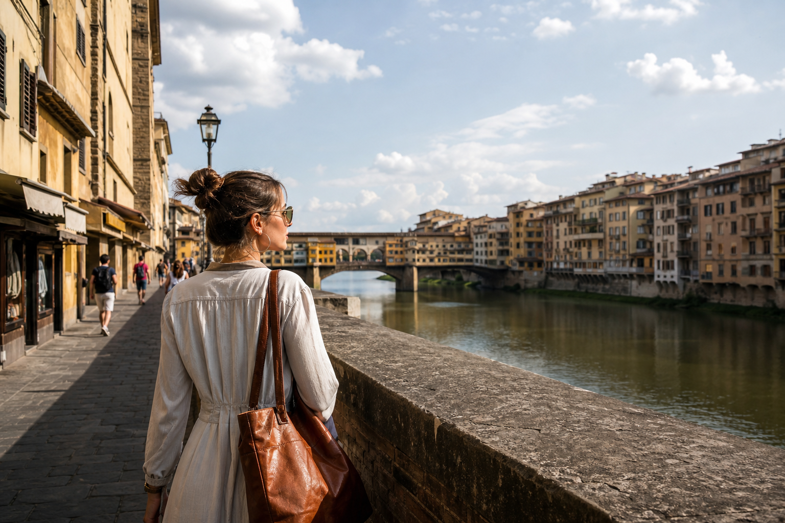 Traveler walking across Ponte Vecchio with Arno river views